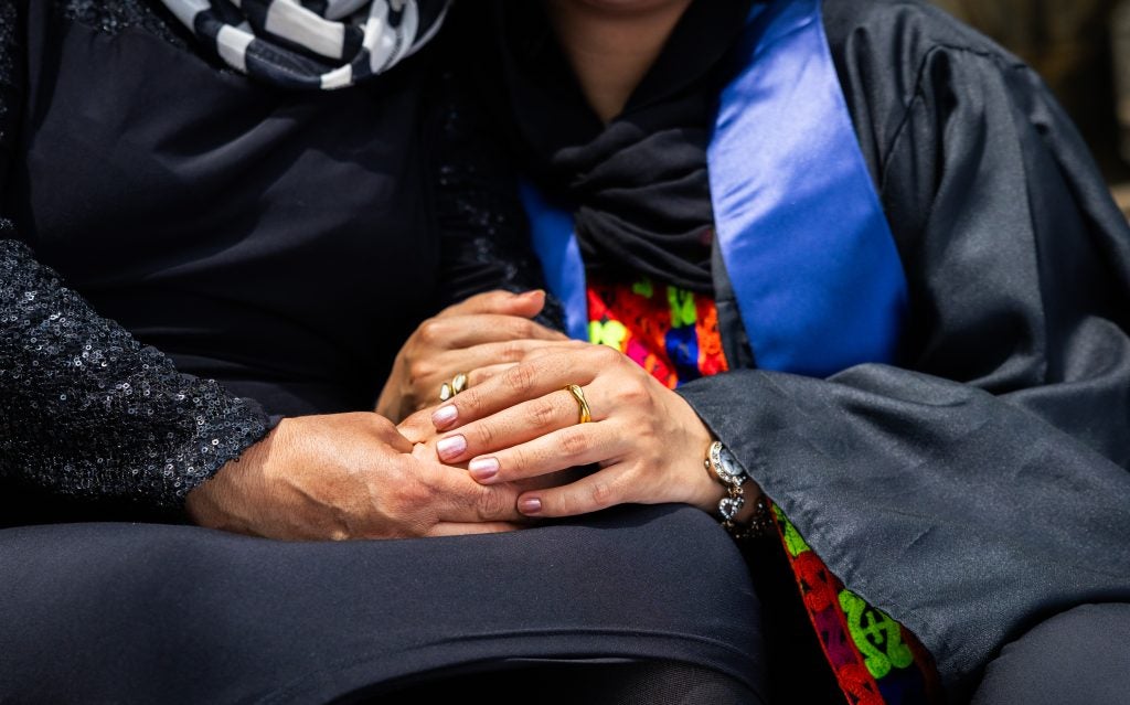 A mother and daughter hold hands