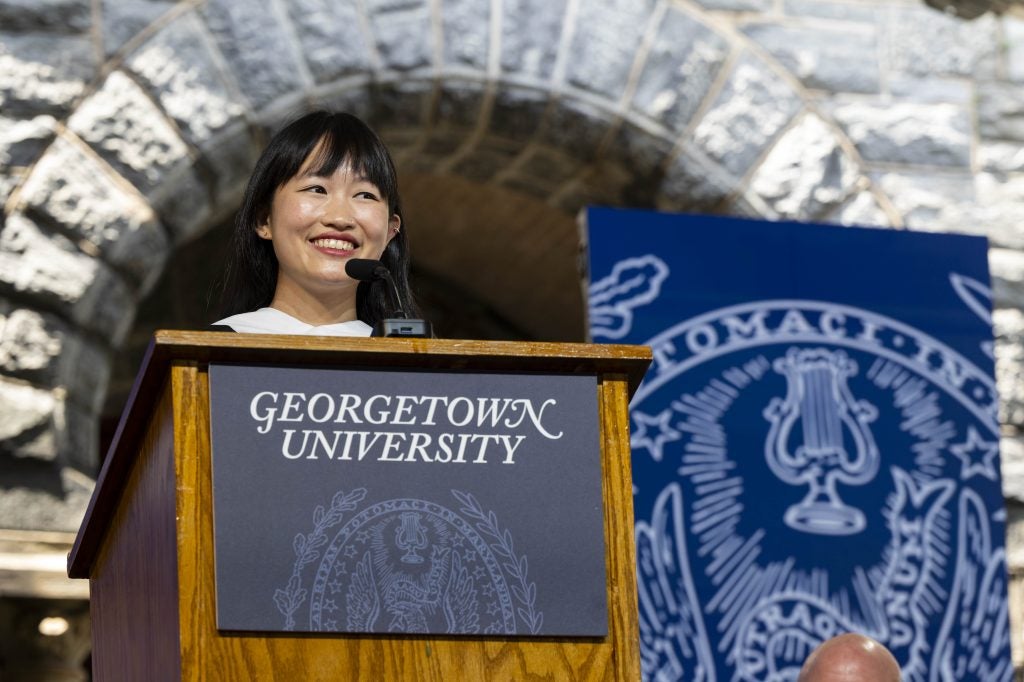Young Asian woman speaking at a podium