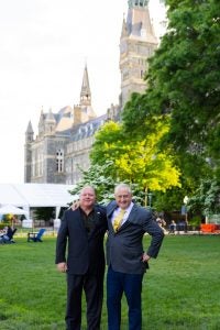 Alan Himmer and Paul Shmotolokha on Healy Lawn in suits