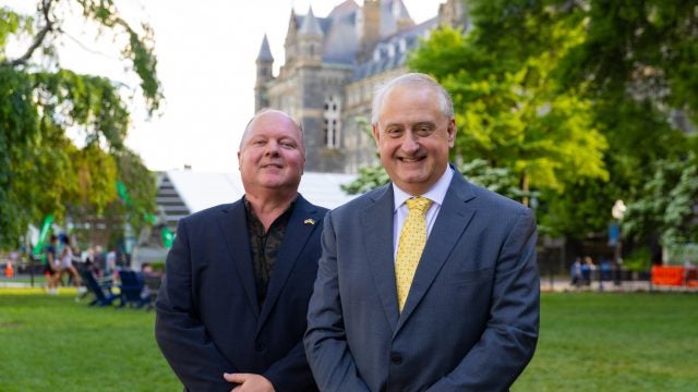 Alan Himmer and Paul Shmotolokha on Healy Lawn in suits