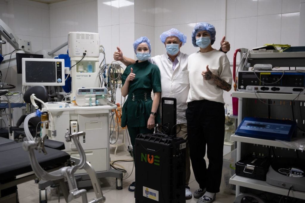 Three healthcare workers with masks in a hospital