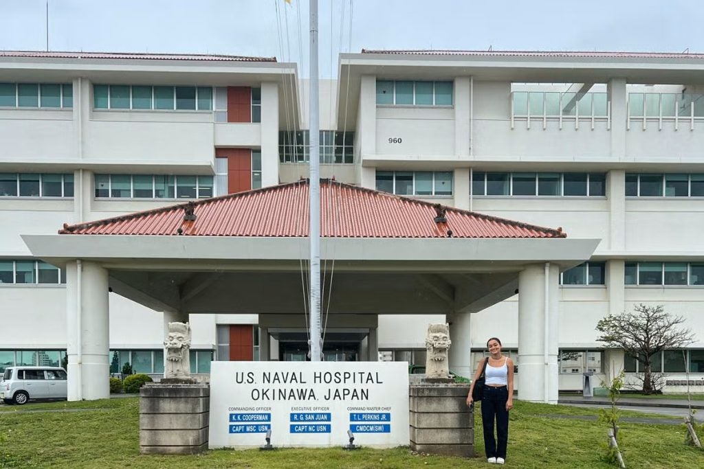 A young woman in front of a hospital 