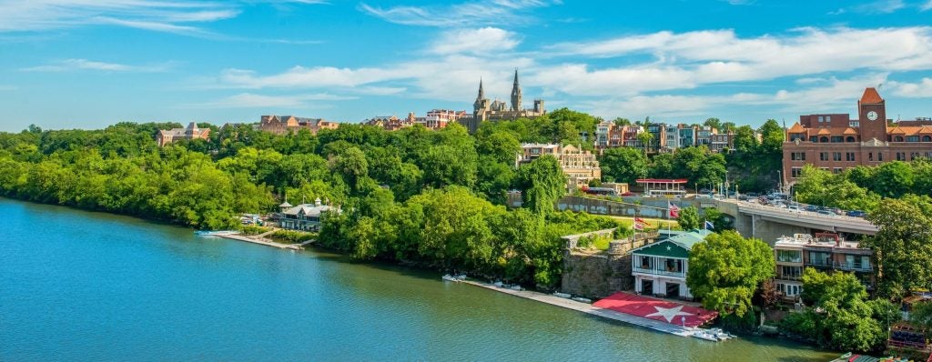The Potomac River and Georgetown's campus on a sunny day