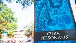 A bright blue sign that says &quot;Cura personalis&quot;