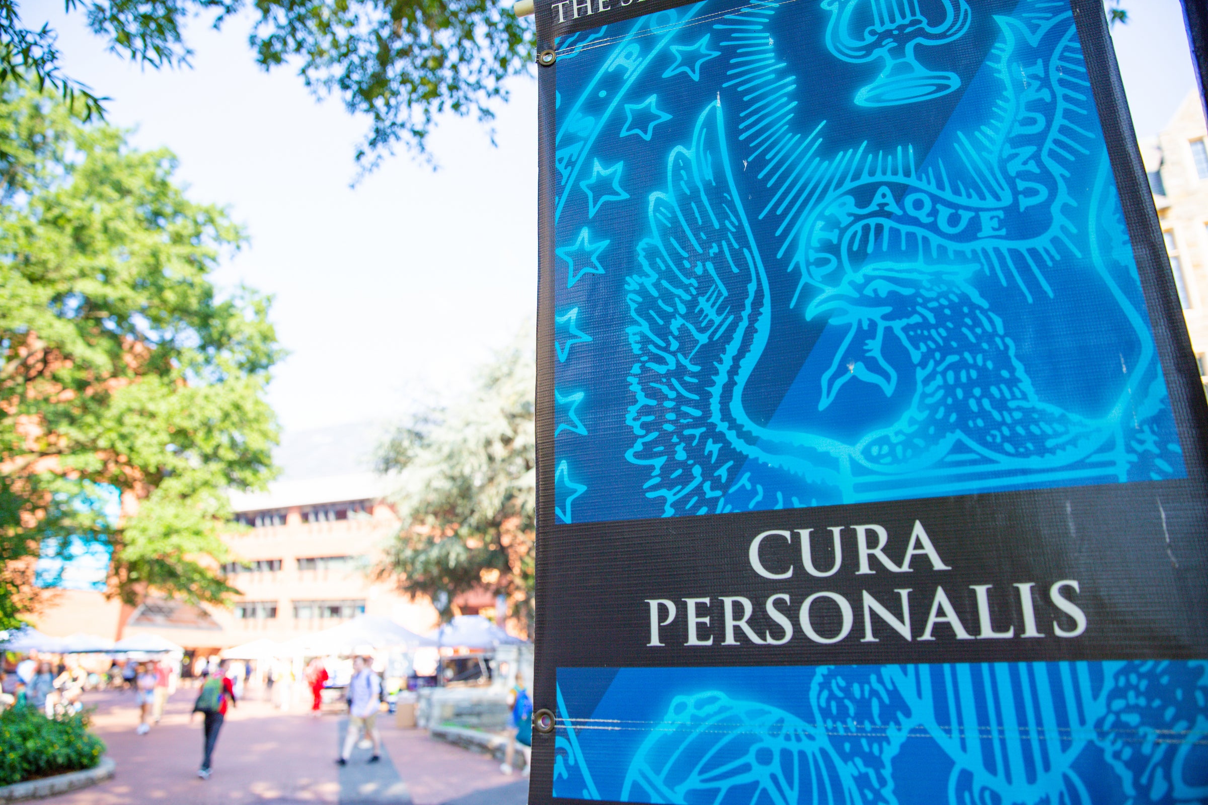 A bright blue sign that says "Cura personalis"