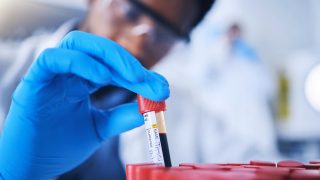 Blood test tubes in hand