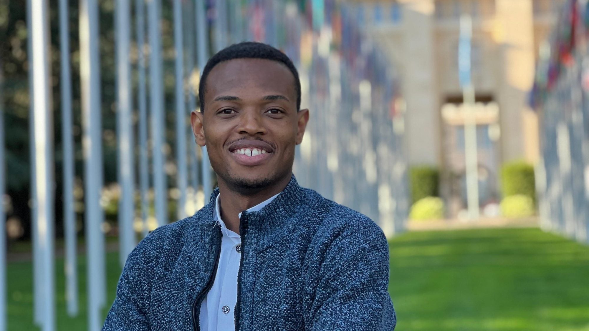 Portrait of Obinna in a blue sweater at the UN
