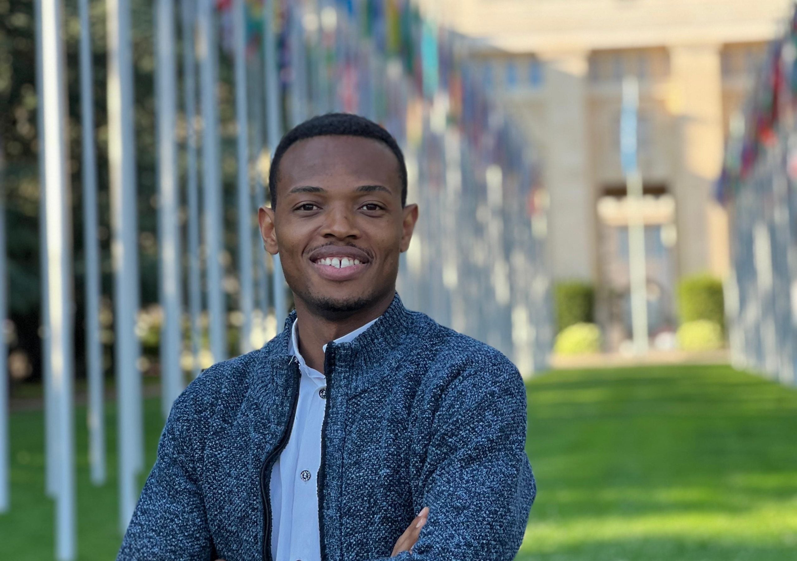 Portrait of Obinna in a blue sweater at the UN