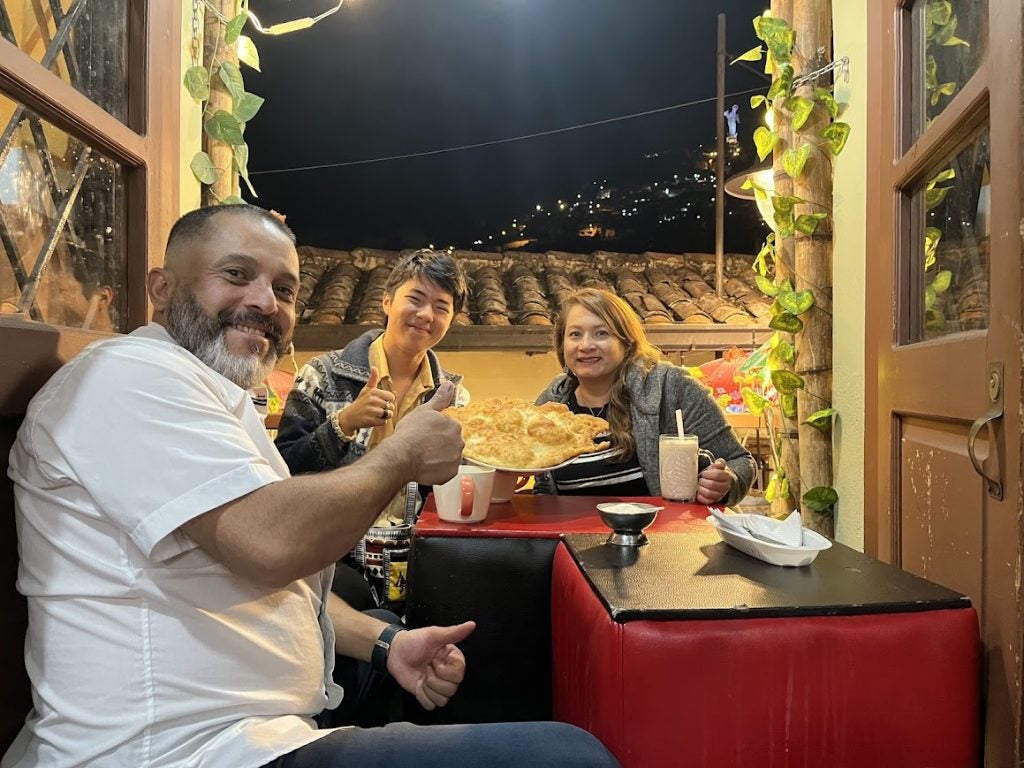 Jeremy with his host parents at night for dinner