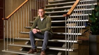 A man sits on a staircase