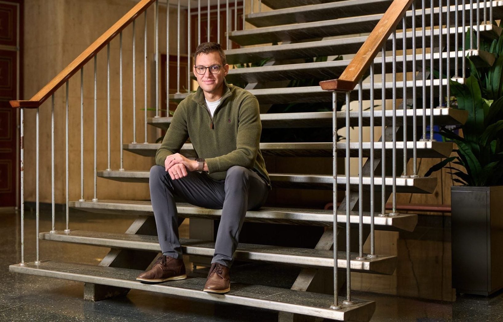 A man sits on a staircase
