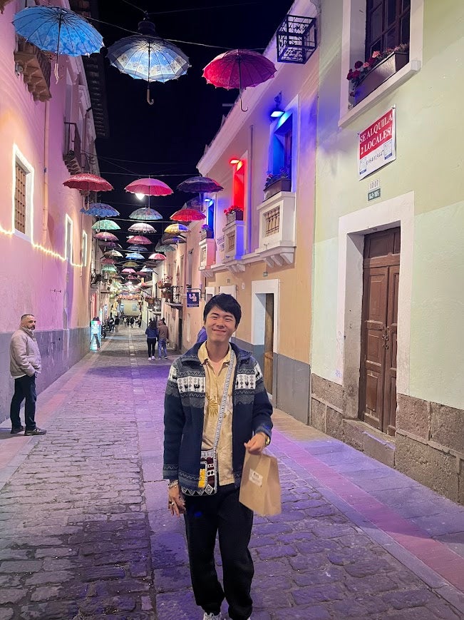 Young Asian man at night in Quito