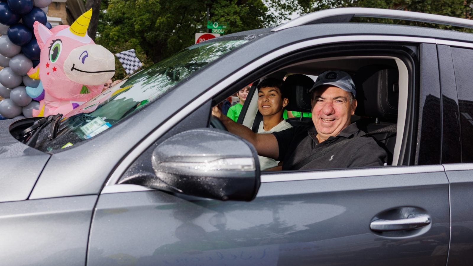 A dad smiles out of the window of his car as he arrives at Georgetown