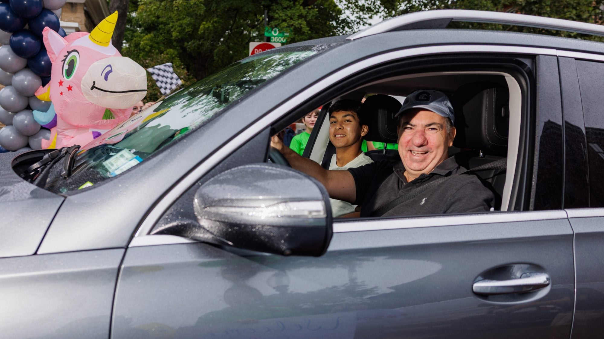 A dad smiles out of the window of his car as he arrives at Georgetown
