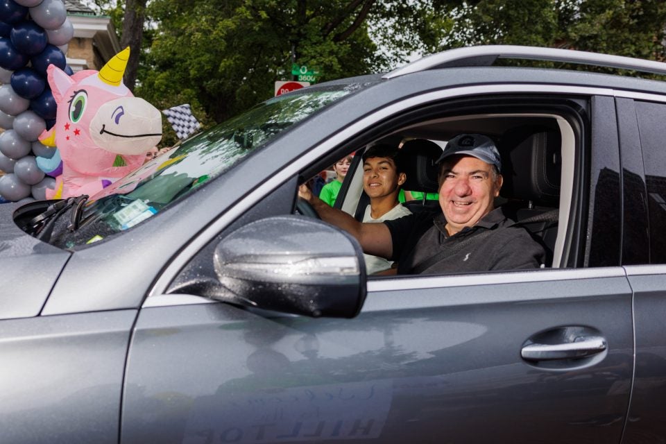 A dad smiles out of the window of his car as he arrives at Georgetown