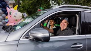 A dad smiles out of the window of his car as he arrives at Georgetown