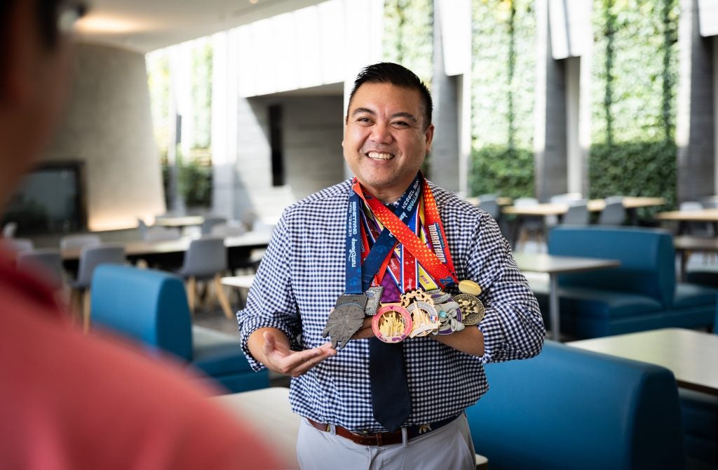 Patrick shows off his medals from running races