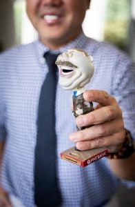 Patrick holding a bobblehead of Teddy Roosevelt