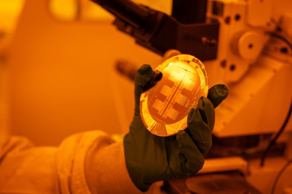 Gloved hand holds a circular disc