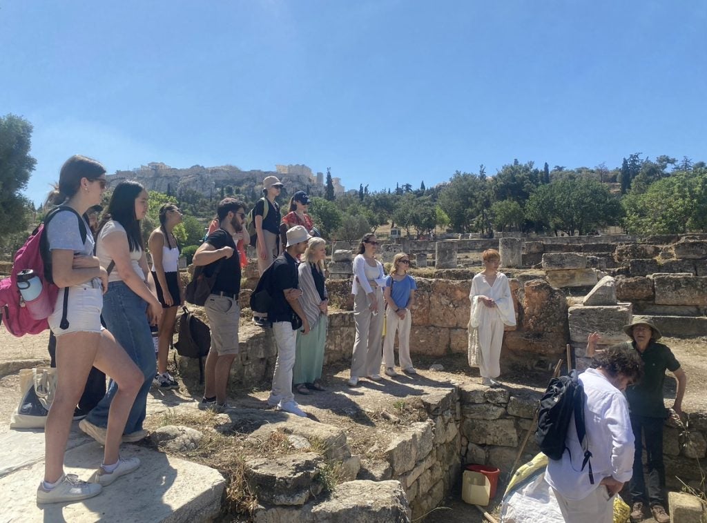 Students tour an ancient building being excavated in Athens