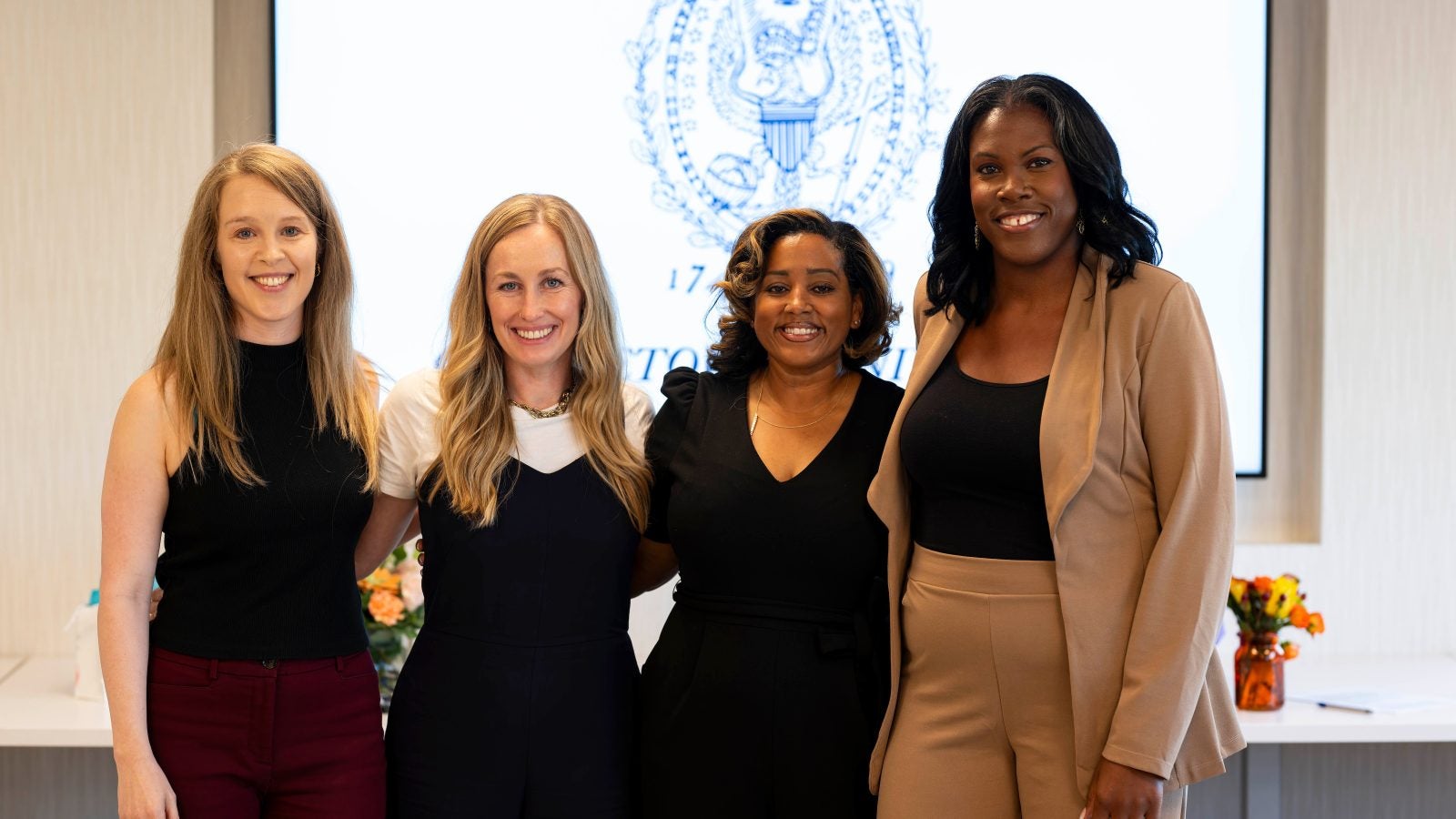 Four female students in the nursing Ph.D. program gather together.
