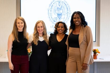 Four female students in the nursing Ph.D. program gather together.