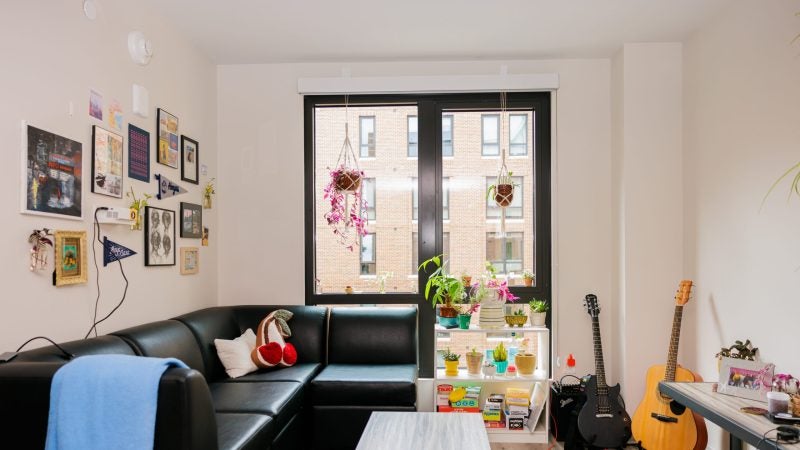 A furnished apartment with a couch and guitars