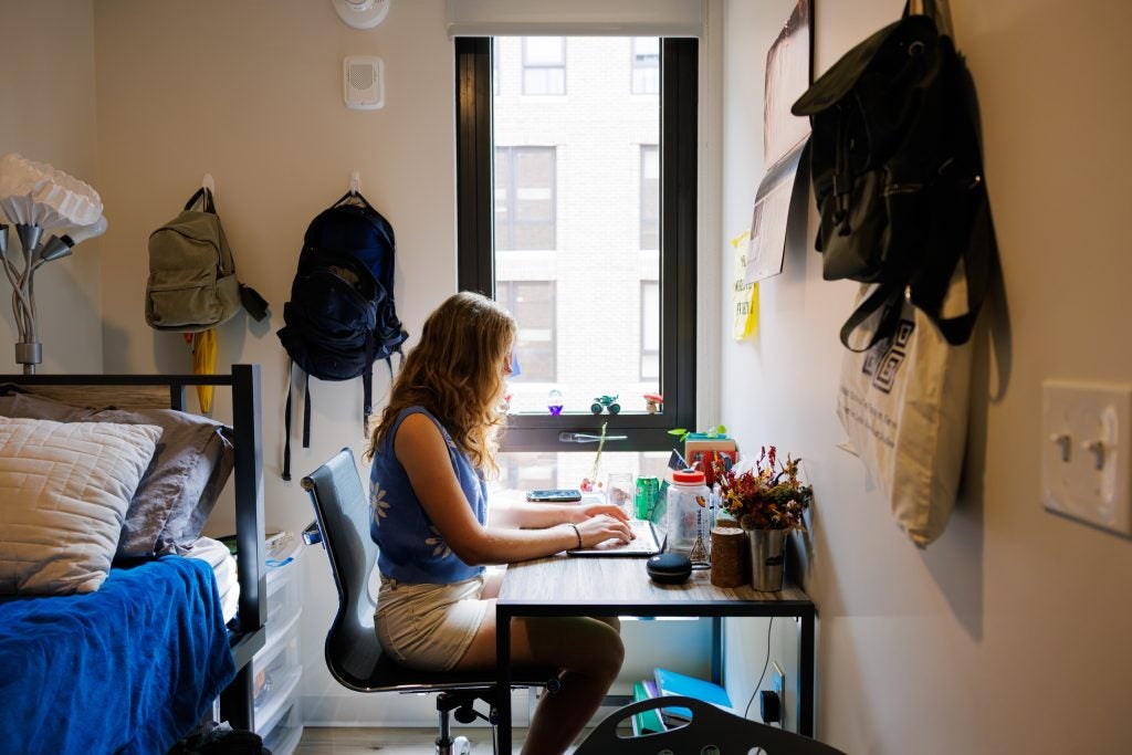 Student at her desk in her apartment