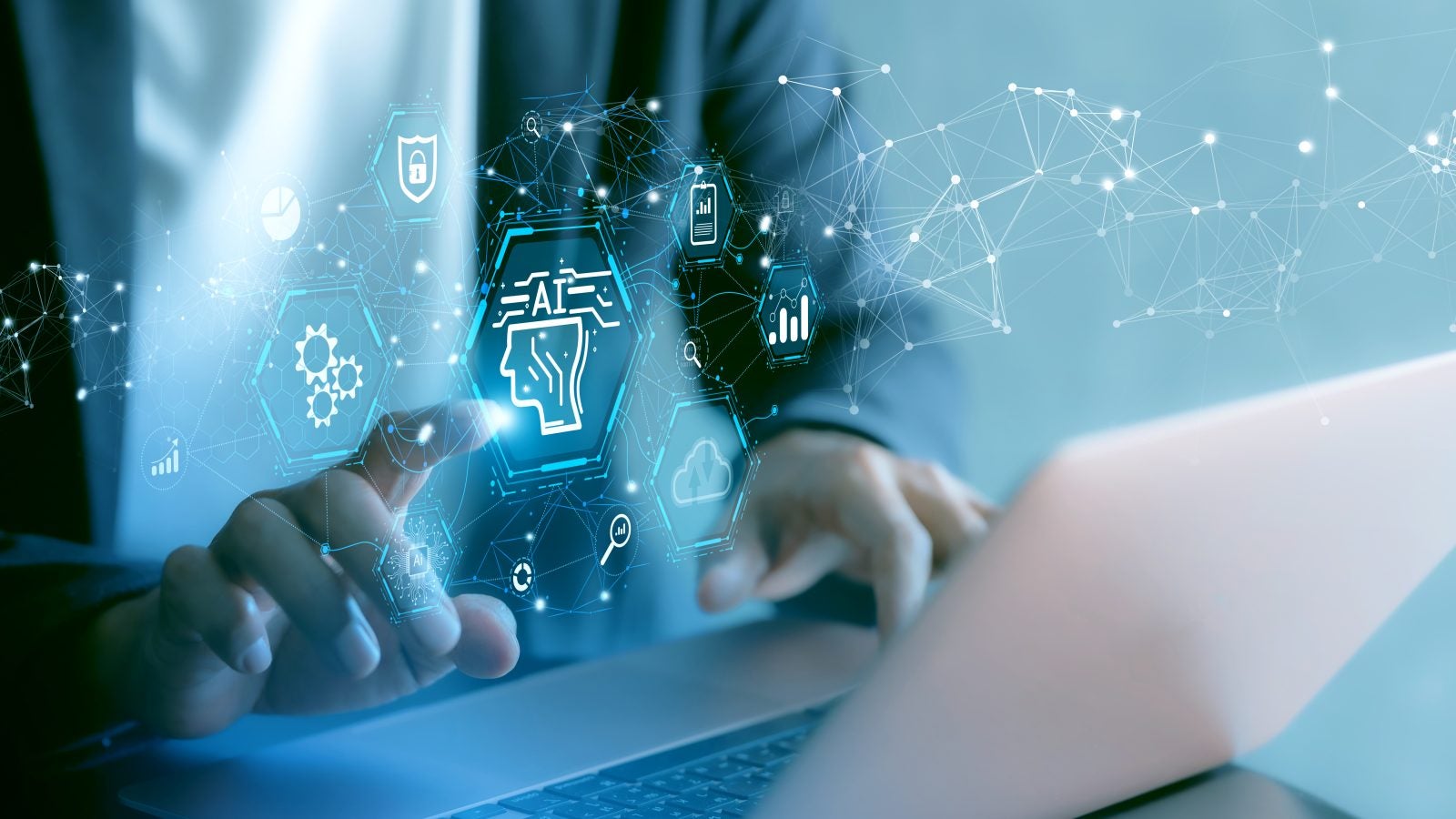 A person types on a computer as a graphic with numbers and the word &quot;AI&quot; pops up
