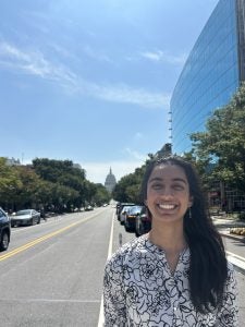 A young woman in front of the U.S. Capitol.