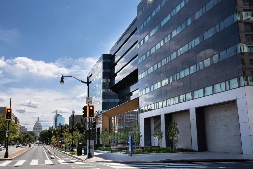 An office building with the U.S. Capitol in the background