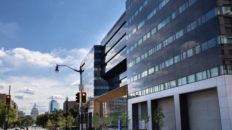 An office building with the U.S. Capitol in the background