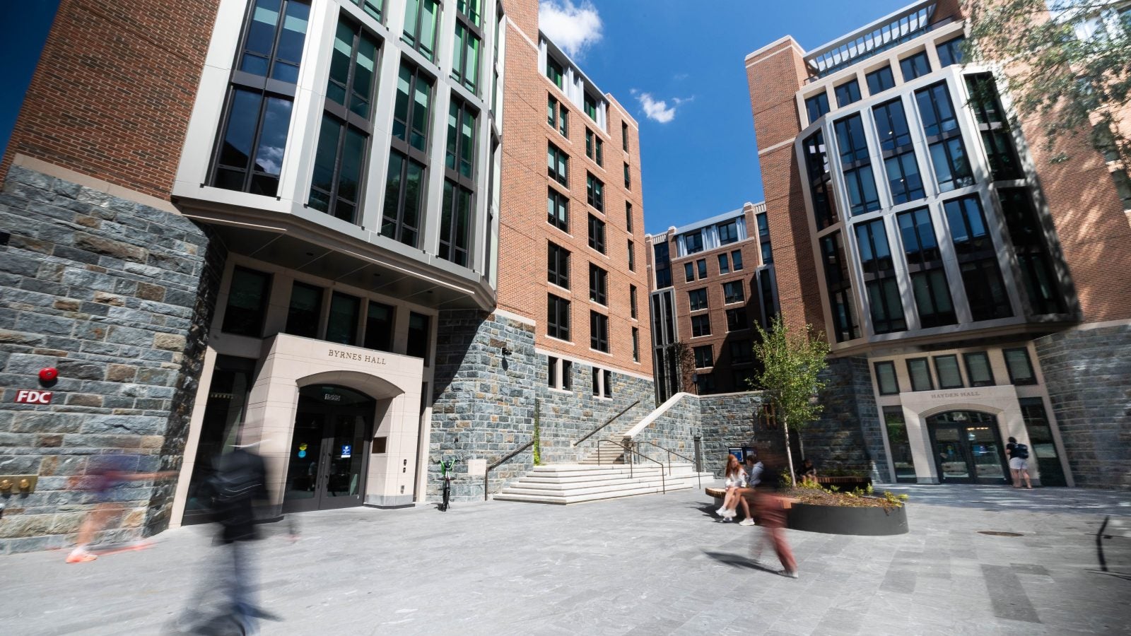 Students walk past a residence hall
