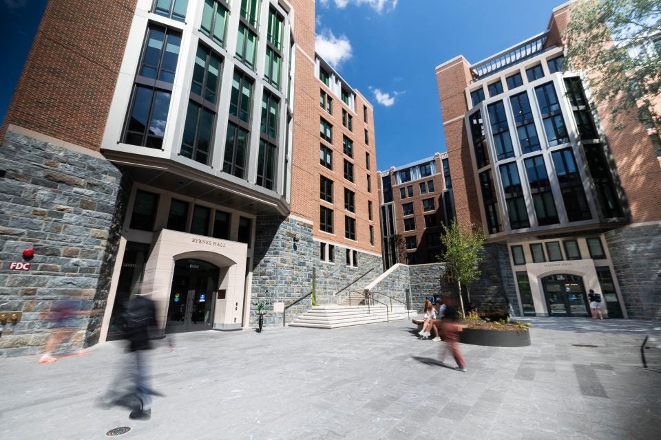 Students walk past a residence hall