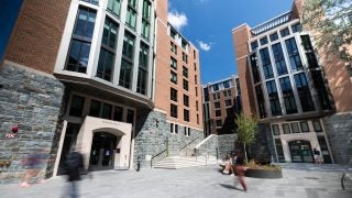 Students walk past a residence hall
