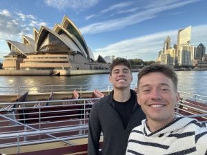 Two young men on a sunny day with the Sydney Opera House in the background