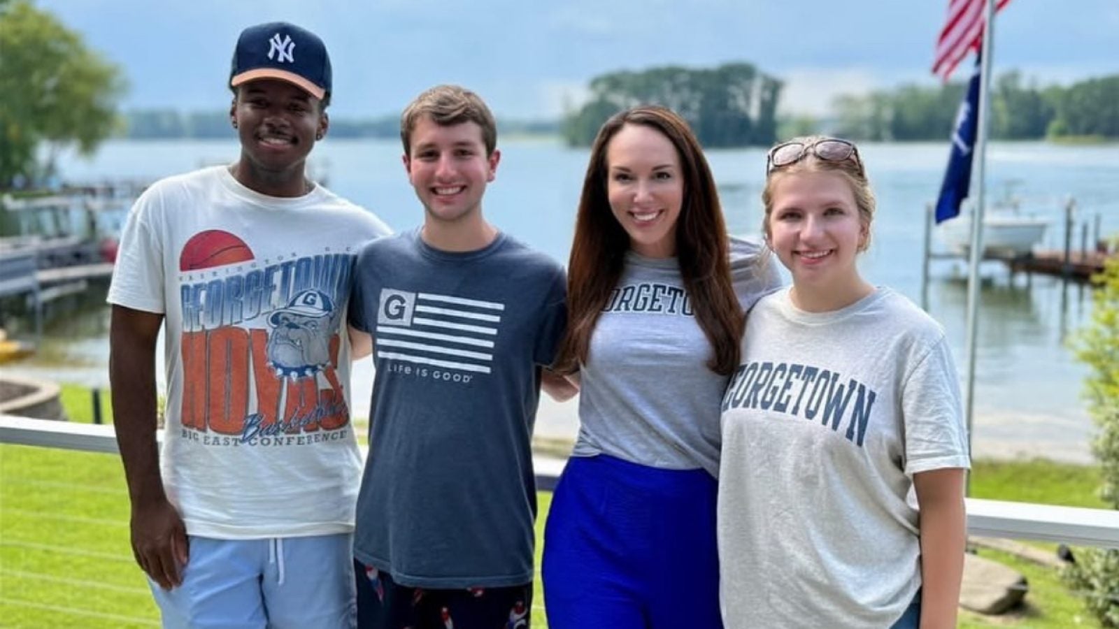 Three students with AP Journalist Meg Kinnard at a lake