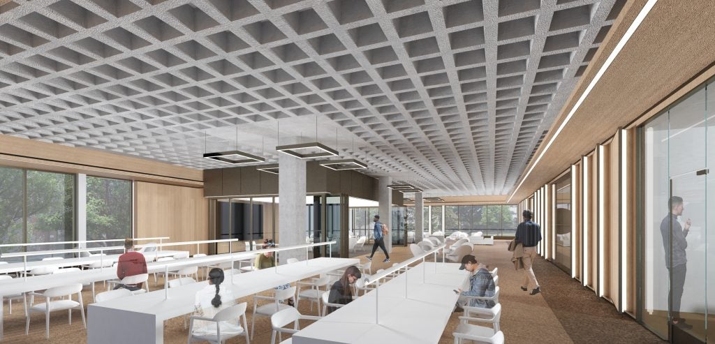A rendering of a modern study space with long white tables