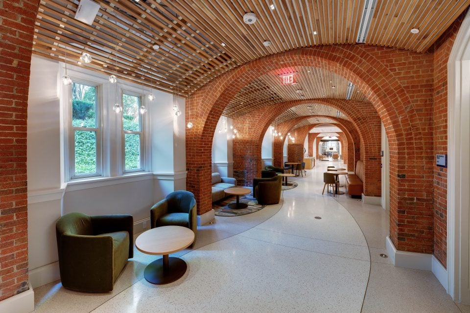 A hallway winds through a brick archway
