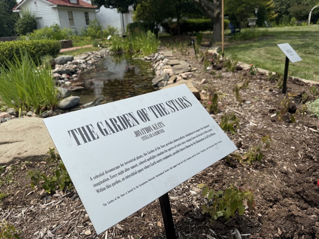 A plaque reads "The Garden of the Stars" in a garden