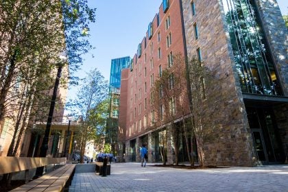 A walkway through two buildings on a sunny day
