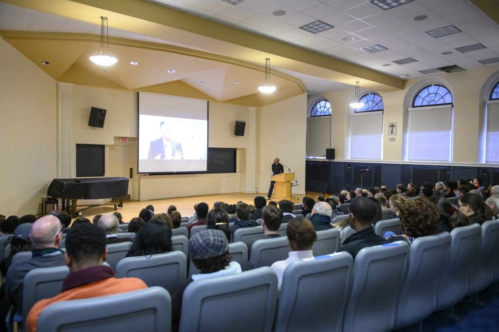An audience sits in an auditorium