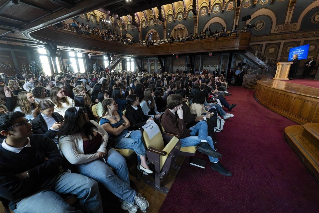 A crowd in Gaston Hall watching Hillary Clinton speak