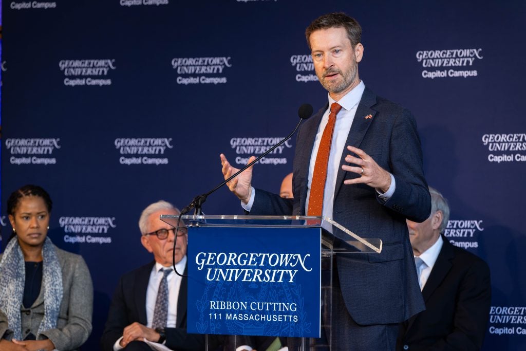 Charles Allen speaks at a podium