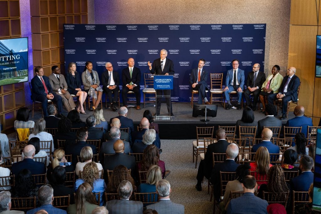 Robert Groves speaks at a podium to an audience