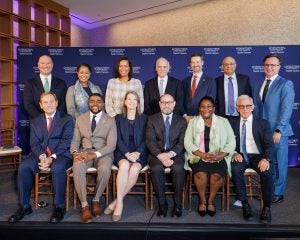 DC leaders with university leaders on stage