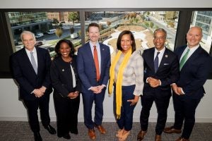 University leaders with DC government leaders smile for a photo