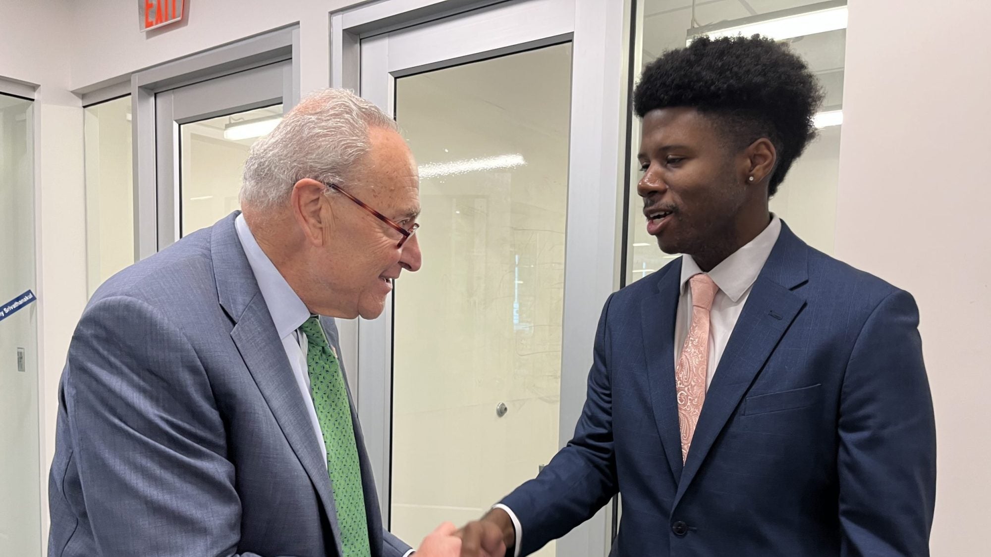 Justin Higgins shakes hands with Chuck Schumer