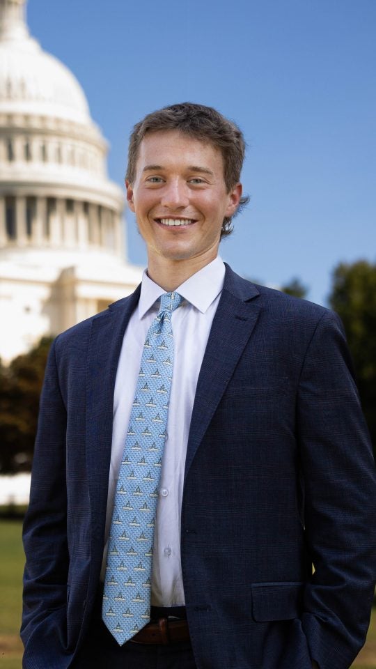 Luke at the Capitol in a blue suit and tie