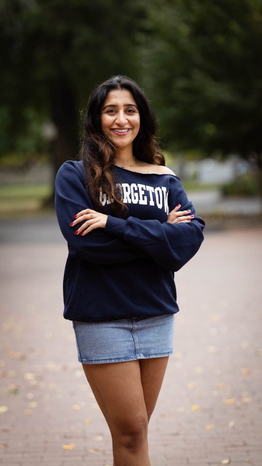 Harnoor in a blue GU sweatshirt on a fall day